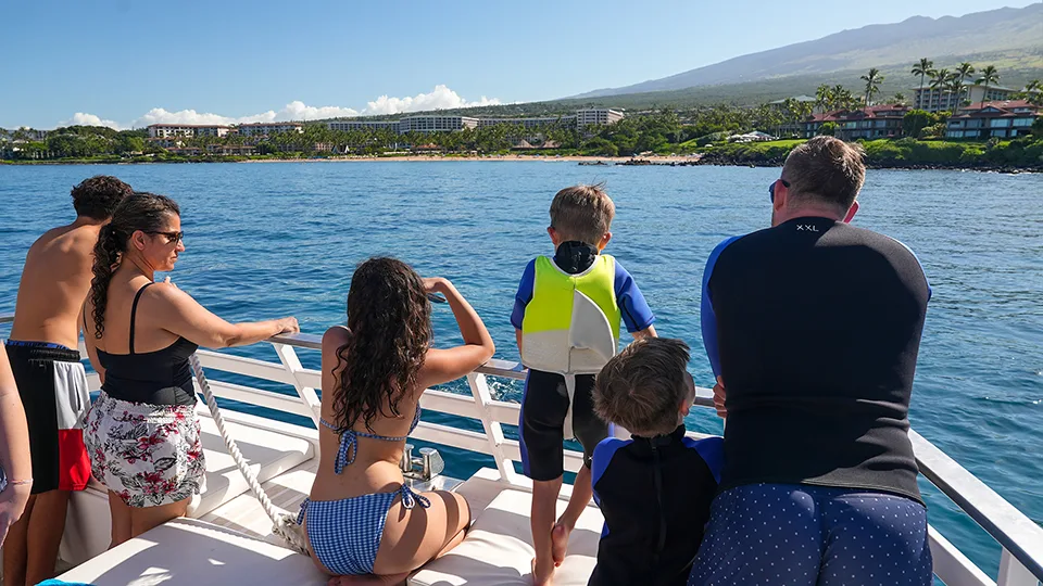 Papi's Ohana team members and family watch humpback whales from Pride of Maui 'Elua
