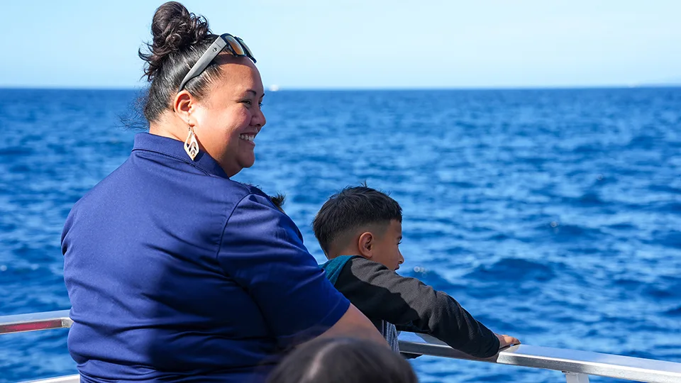 Maui Food Bank team member and child whale watching