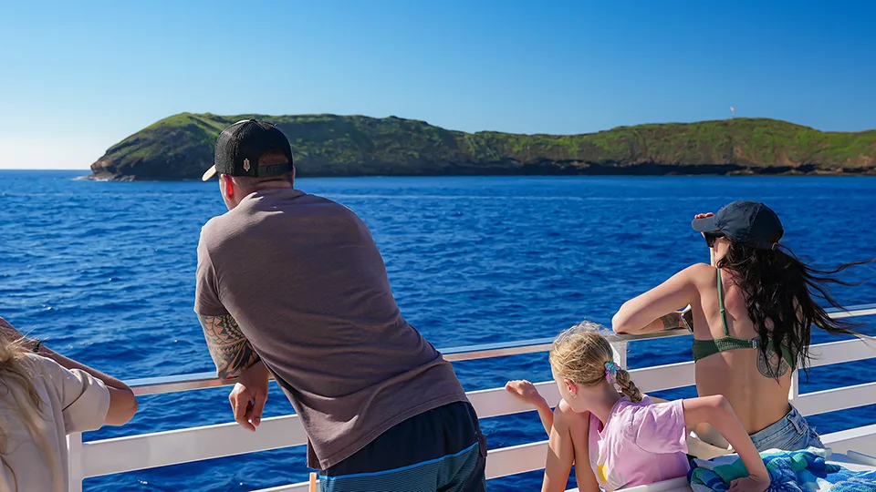 Guests aboard the Pride of Maui ʻElua looking out toward Molokini Crater during a Maui snorkeling tour.