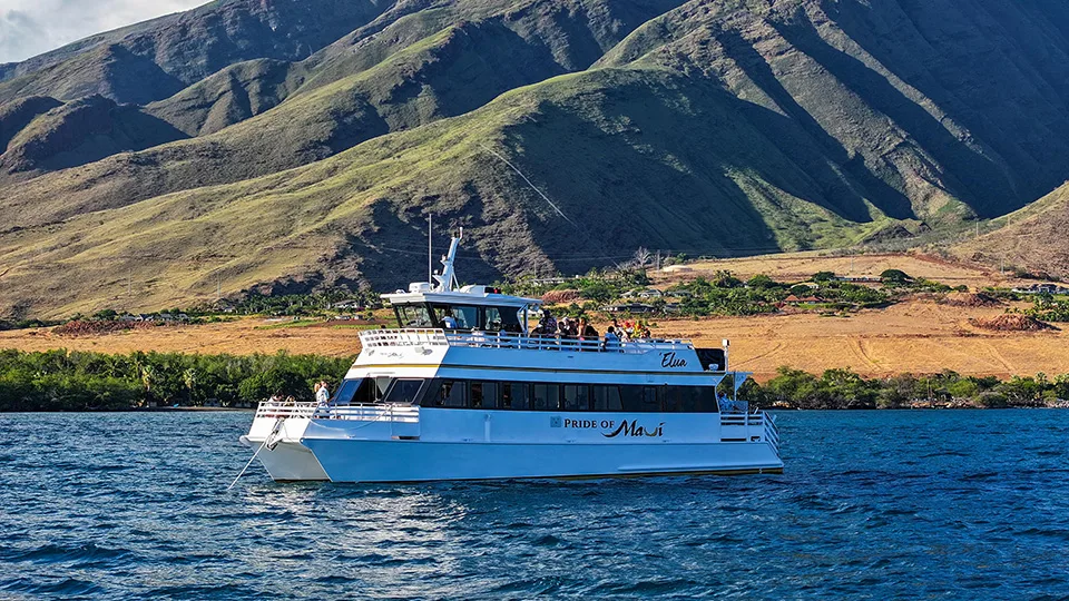 Side profile of Pride of Maui ʻElua power catamaran underway on calm Maui ocean