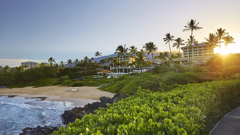 Sunrise casting golden light over the Grand Wailea resort.