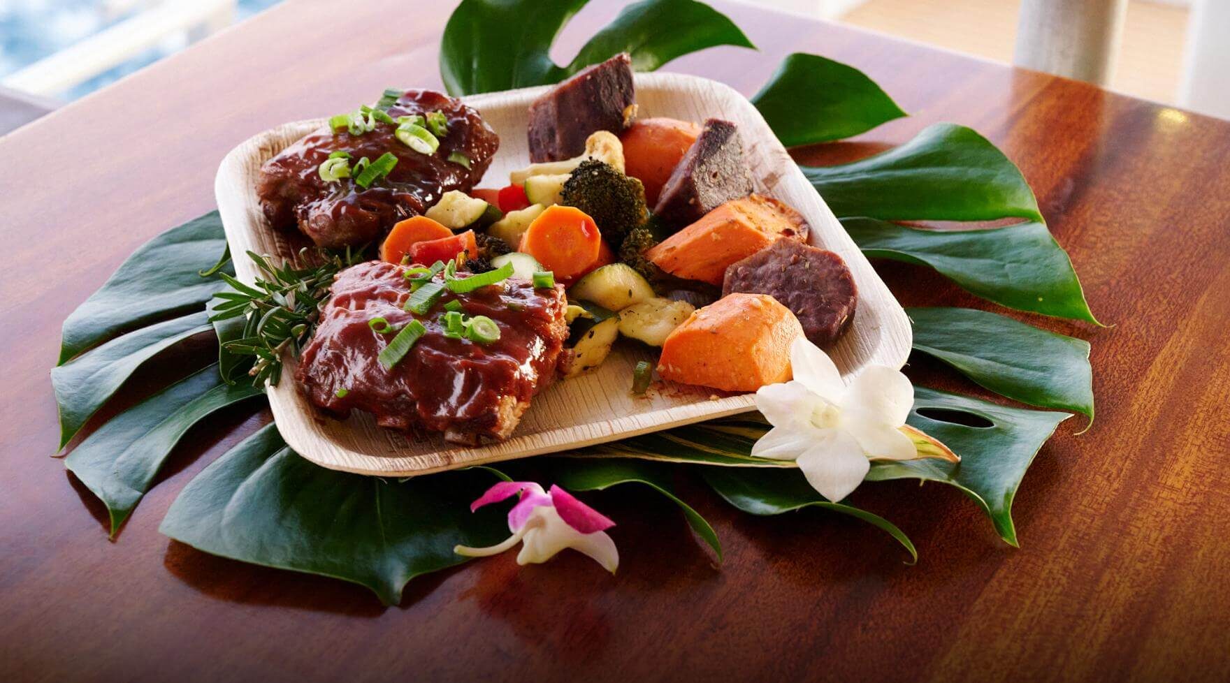 Island-style dinner plate with barbecue ribs, roasted vegetables, and sweet potatoes aboard the Pride of Maui Sunset Dinner Cruise