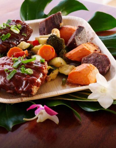Island-style dinner plate with barbecue ribs, roasted vegetables, and sweet potatoes aboard the Pride of Maui Sunset Dinner Cruise