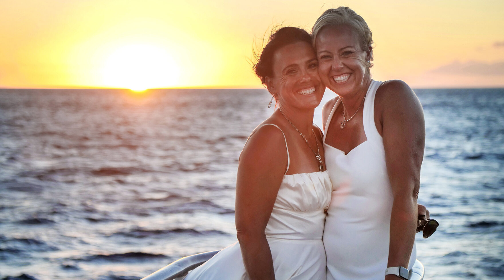 Bridal Couple Smiling at Sunset on a Pride of Maui Wedding Cruise
