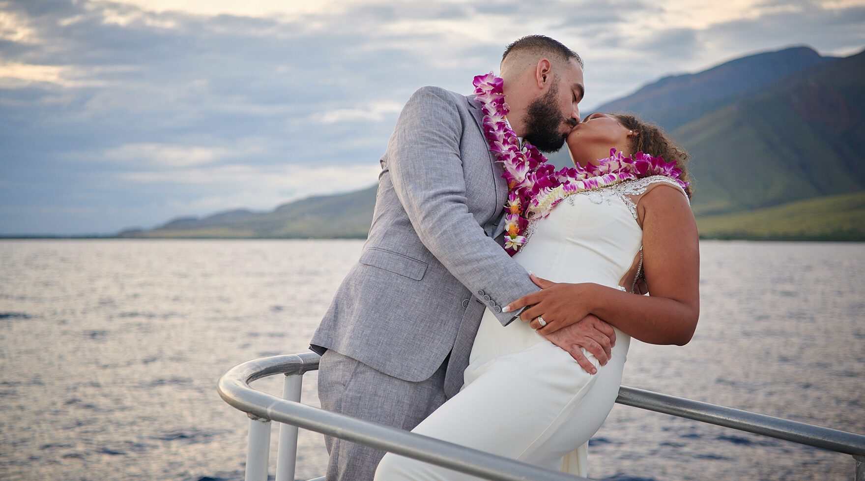 Bridal Couple Kissing on a Pride of Maui Wedding Cruise