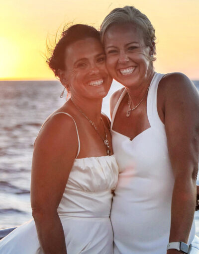 Bridal Couple Smiling at Sunset on a Pride of Maui Wedding Cruise