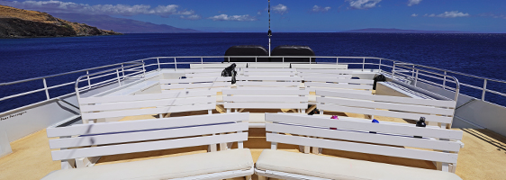 Upper observation deck of the Pride of Maui catamaran with panoramic ocean and sunset views
