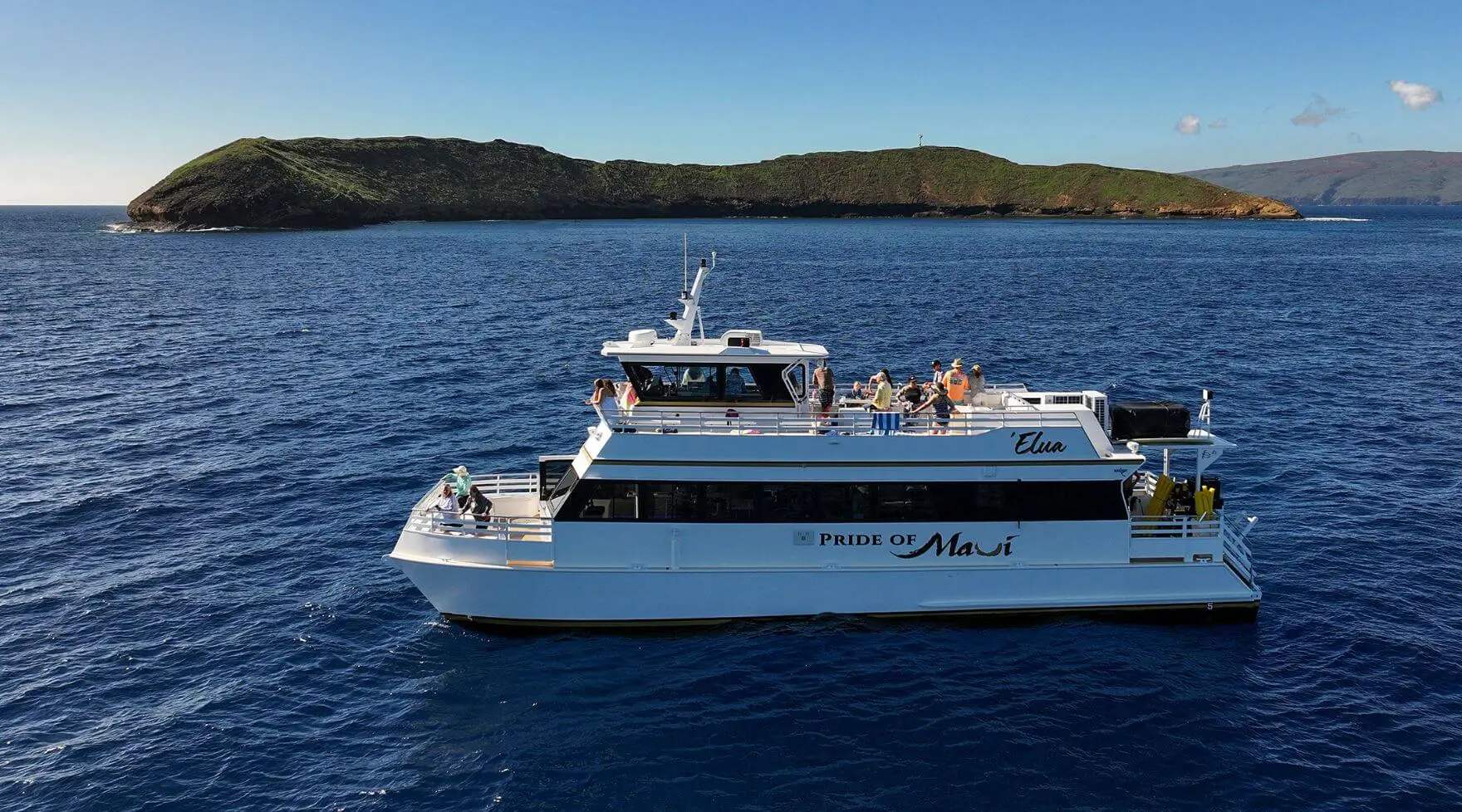 ‘Elua underway by Molokini Crater, morning light, small group on upper deck