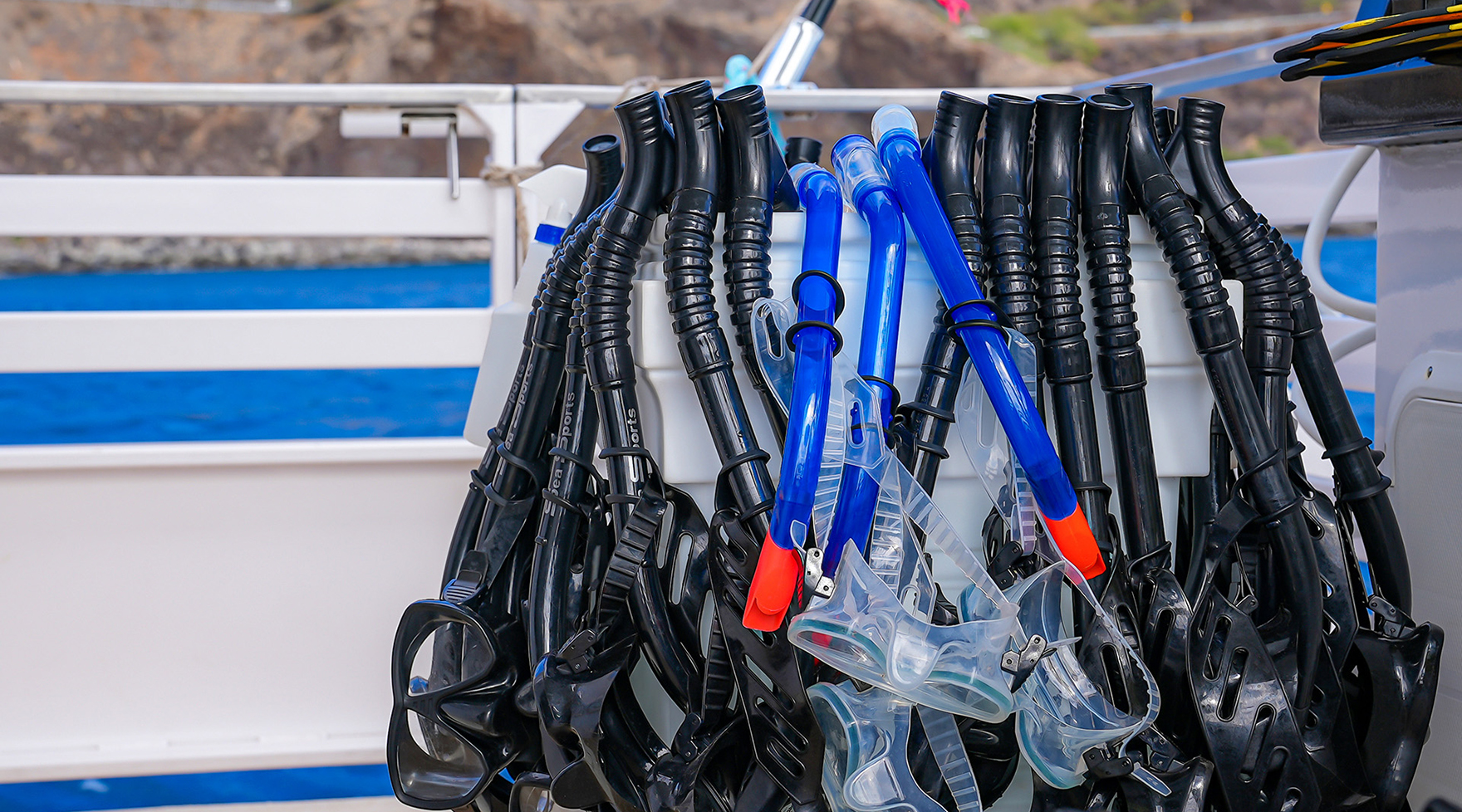Sanitized masks and snorkels organized on ‘Elua’s gear rack