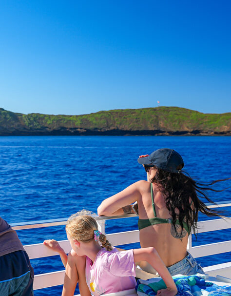 Family watching Molokini from ‘Elua’s rail on a calm morning