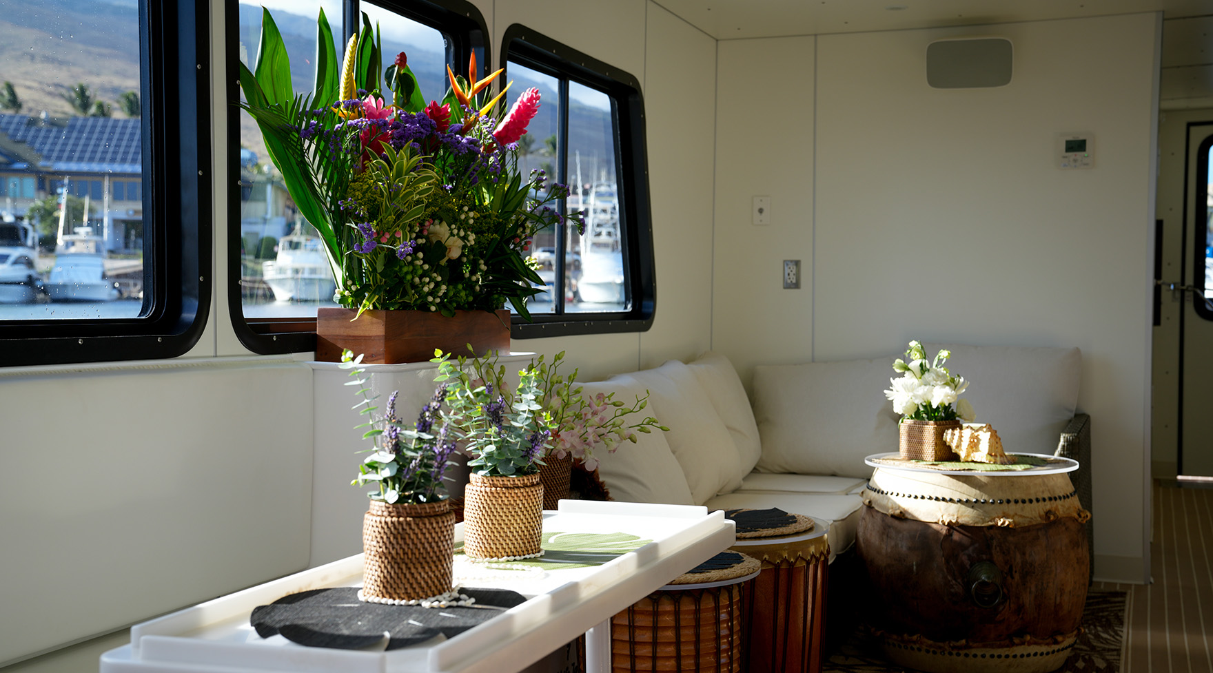 Air-conditioned lounge with shaded seating aboard the ‘Elua catamaran.