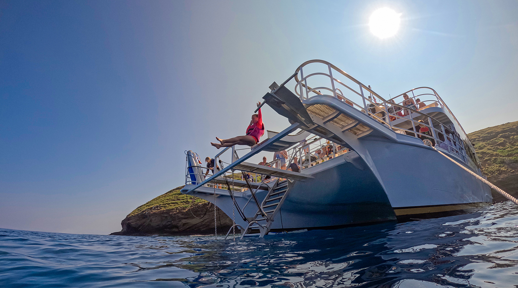 Child using the water slide at Molokini on Pride of Maui